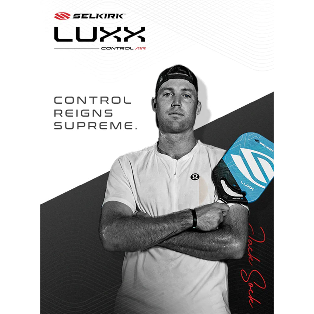 Jack Sock holding the Selkirk Luxx Pickleball Paddle in Blue